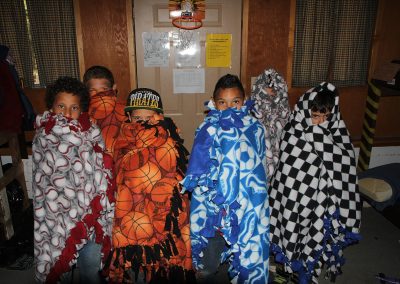 Foster kids covered by blankets.