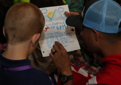 Volunteer reading a letter with a foster kid.